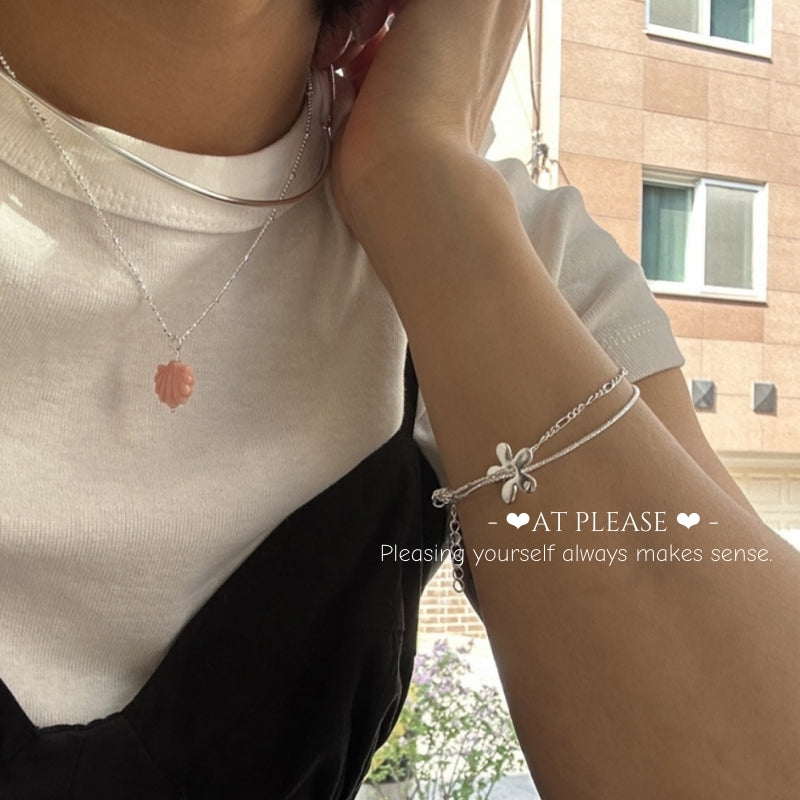 Layered bracelets with coffee cup on marble table